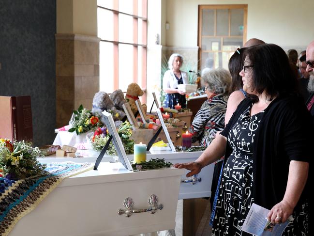 Mourners pay their respects during the funerals of Beverley Quinn, Mara Harvey, and Mara's daughters, Charlotte, Alice, and Beatrix in Perth on Friday, October 12, 2018. All were murdered in their Bedford home in Perth last month. (AAP Image/Richard Wainwright) NO ARCHIVING