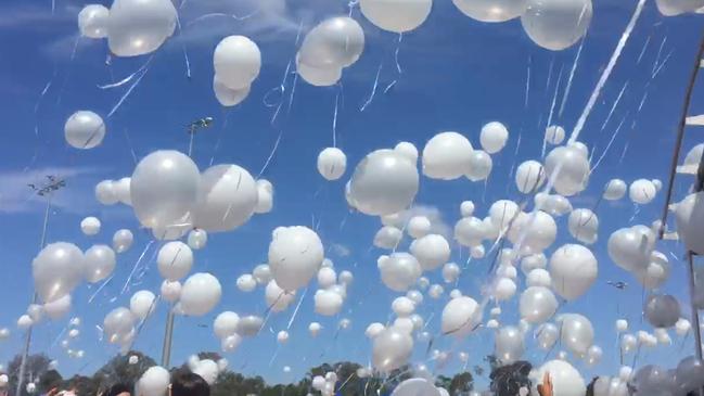 Hundreds of balloons are released at a charity event for Tara Brown.