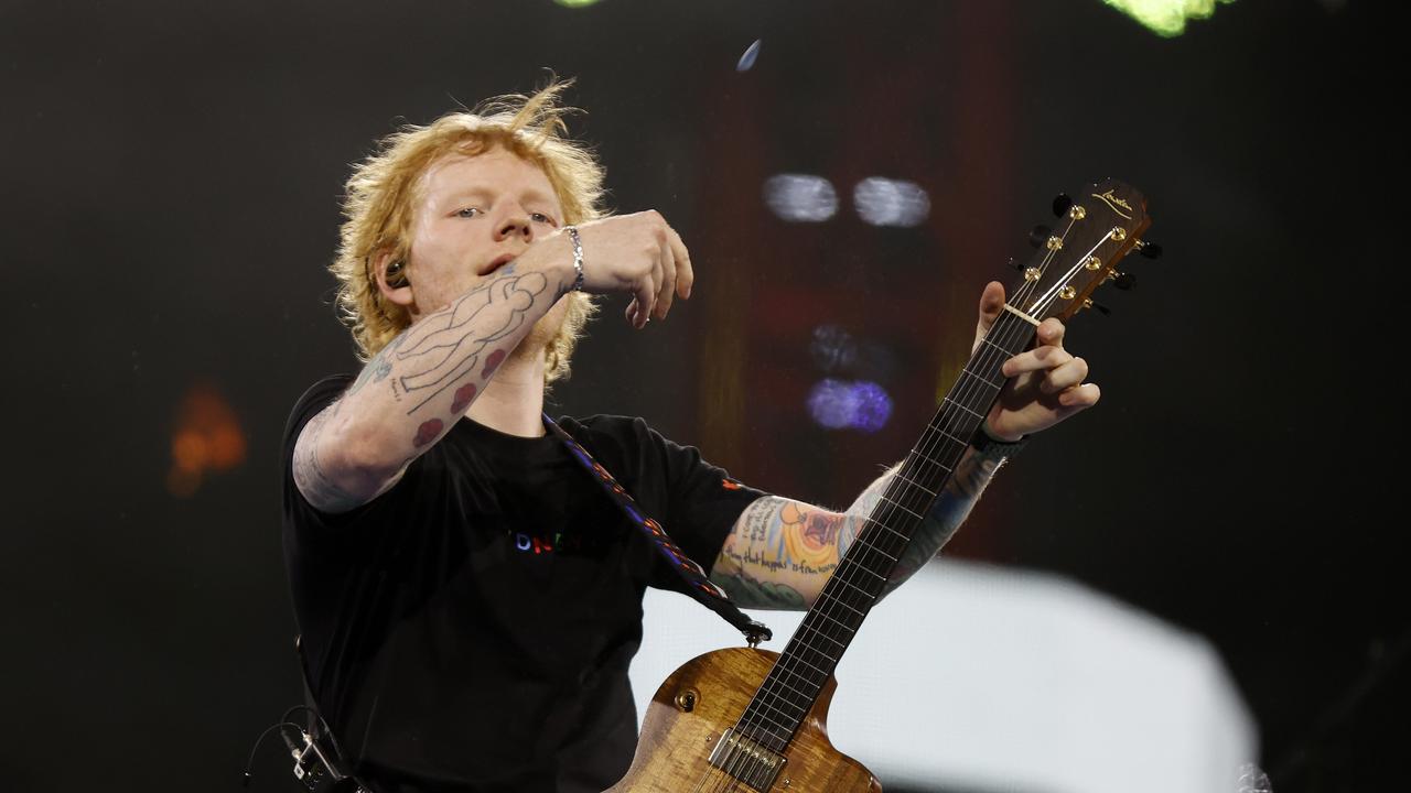 NSW NETWORK  FEBRUARY 24, 2023. Ed Sheeran throws his pick into the crowd during his first Sydney concert at Accor Stadium in Sydney Olympic Park. Picture: Jonathan Ng