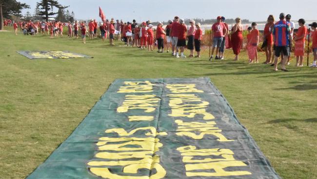 #SaveStocktonBeach protesters used banners to reinforce the anger felt by the thousands who formed a red line against beach erosion. Supplied.