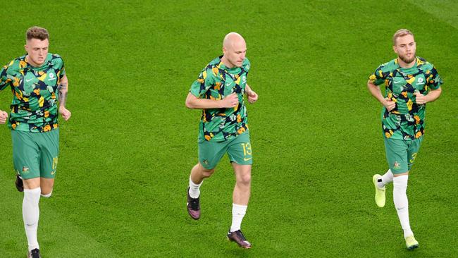 AL WAKRAH, QATAR - NOVEMBER 22: (L-R) Harry Souttar, Aaron Mooy and Nathaniel Atkinson of Australia warm up prior to the FIFA World Cup Qatar 2022 Group D match between France and Australia at Al Janoub Stadium on November 22, 2022 in Al Wakrah, Qatar. (Photo by Stu Forster/Getty Images)