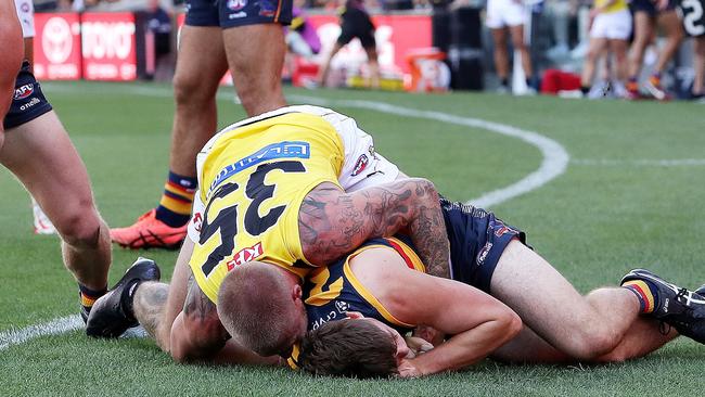 Patrick Parnell is crunched into the turf by Tiger Nathan Broad. Picture: Sarah Reed/AFL Photos via Getty Images