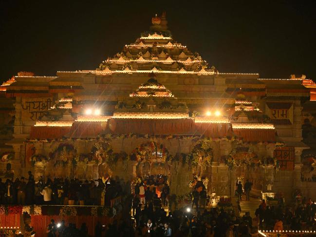 Hindu devotees gather near the illuminated Ram temple following its consecration ceremony in Ayodhya. Picture: Money Sharma/AFP