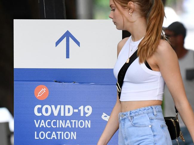 BRISBANE, AUSTRALIA - NewsWire Photos - A teenage girl walks outside a Covid-19 vaccination hub at Southbank in Brisbane. Queensland will open its borders on December 13. Picture: NCA NewsWire / Dan Peled