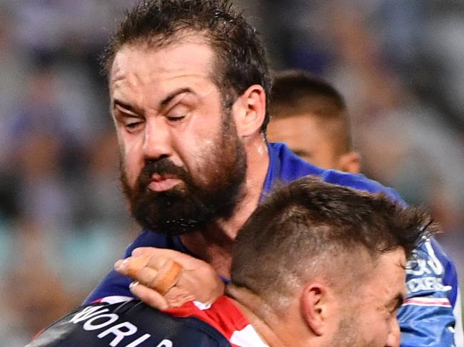 Bulldogs Aaron Woods is tackled during the Round 7 NRL match between the Canterbury-Bankstown Bulldogs and the Sydney Roosters at ANZ Stadium in Sydney, Thursday, April 19, 2018. (AAP Image/Mick Tsikas) NO ARCHIVING, EDITORIAL USE ONLY