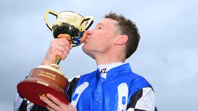 Gold Trip jockey Mark Zahra kisses the Melbourne Cup. Photo by Quinn Rooney/Getty Images