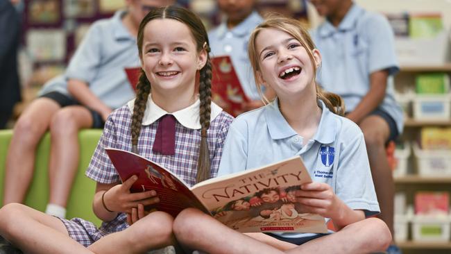 Year 5 students Elodie, left, and Faith reading at St Thomas Aquinas Primary School in Canberra. Picture: Martin Ollman