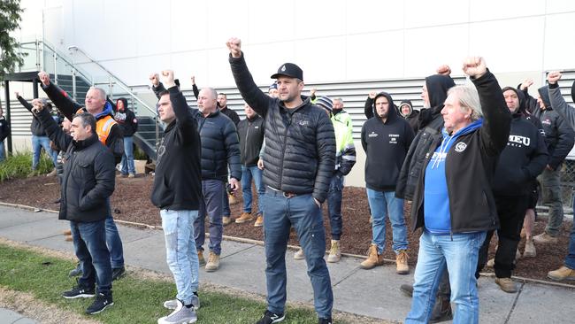 Construction workers blocking Toorak Rd on Wednesday morning. Picture: David Crosling