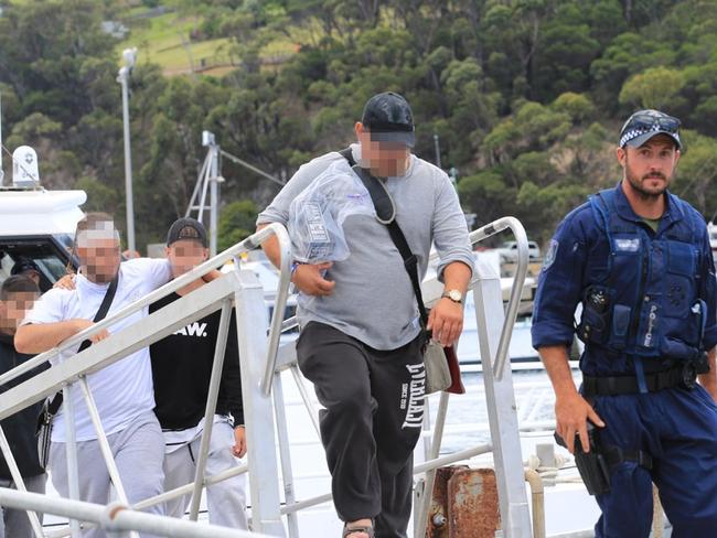 Passengers from the Carnival Legend being taken off the cruise ship by police in an unscheduled stop in Eden, NSW.