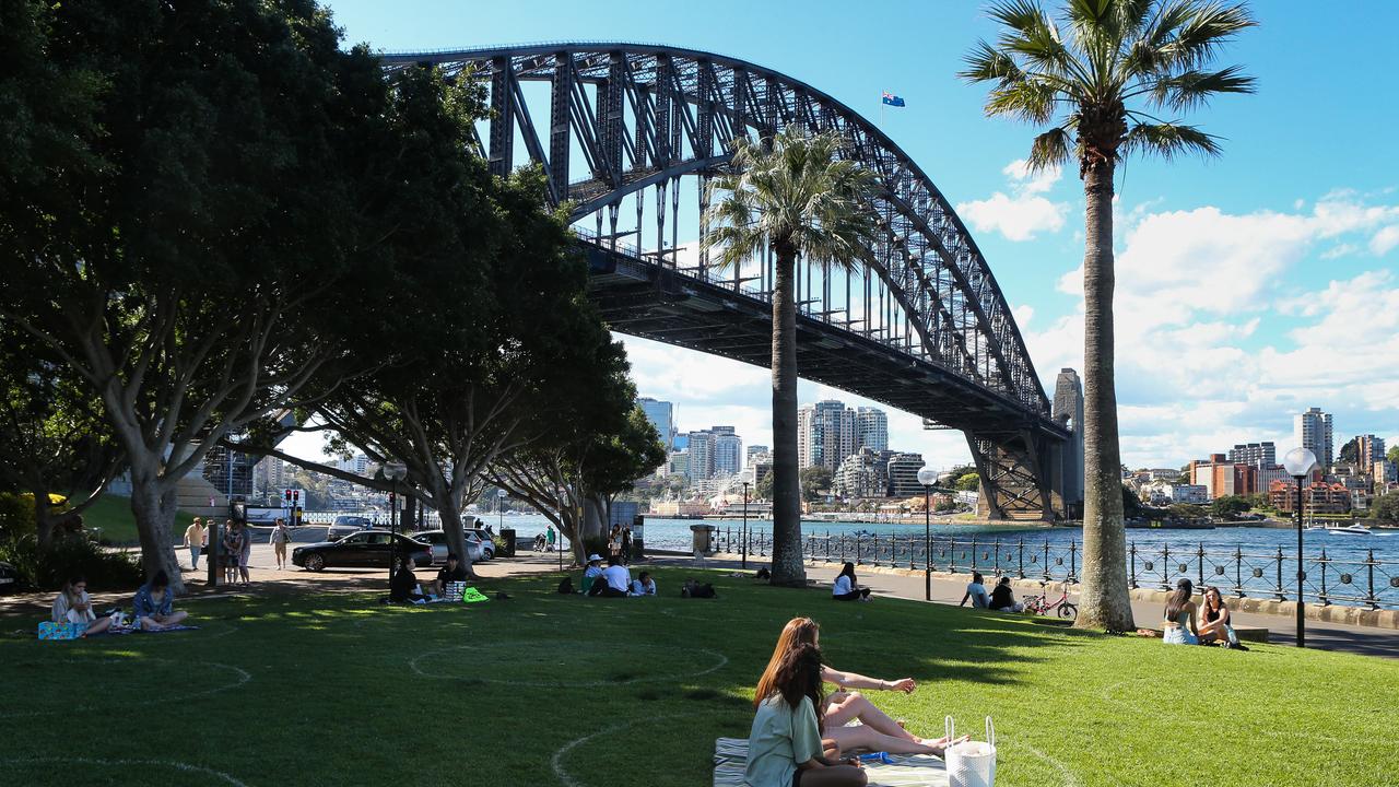 People are seen enjoying the warm weather and having a picnic in Sydney. Picture: NCA NewsWire / Gaye Gerard