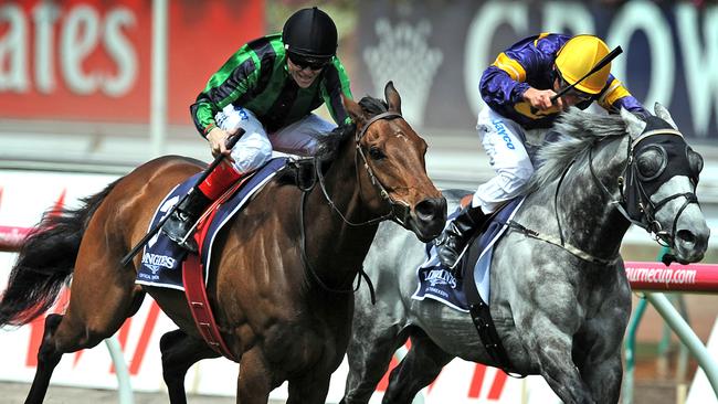 Craig Williams rides Alcopop (left) overtakes Glass Harmonium to win the 2012 Mackinnon Stakes. Picture: AAP