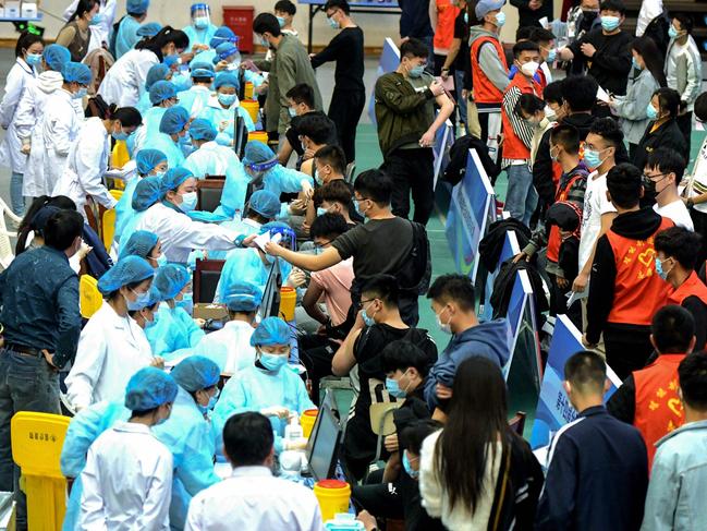 Chinese university students queue to receive the Sinovac vaccine. Picture: AFP