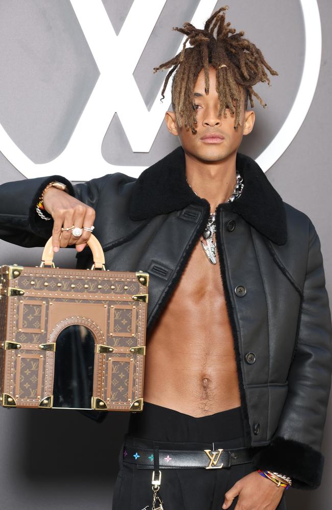 A shirtless Jaden Smith concentrates as he holds a Louis Vuitton Malle Arc de Triomphe Arch mini trunk bag, which retails for the wild amount of $57,000. Picture: Pascal Le Segretain/Getty Images