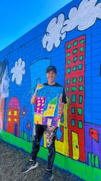 Artist Miss Polly begins mural on first day of Palmerston Street Art Festival