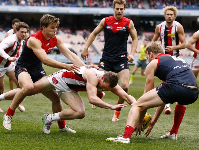 Jack Newnes dives on the ball in front of Jack Watts and Jack Viney. Picture: Wayne Ludbey.