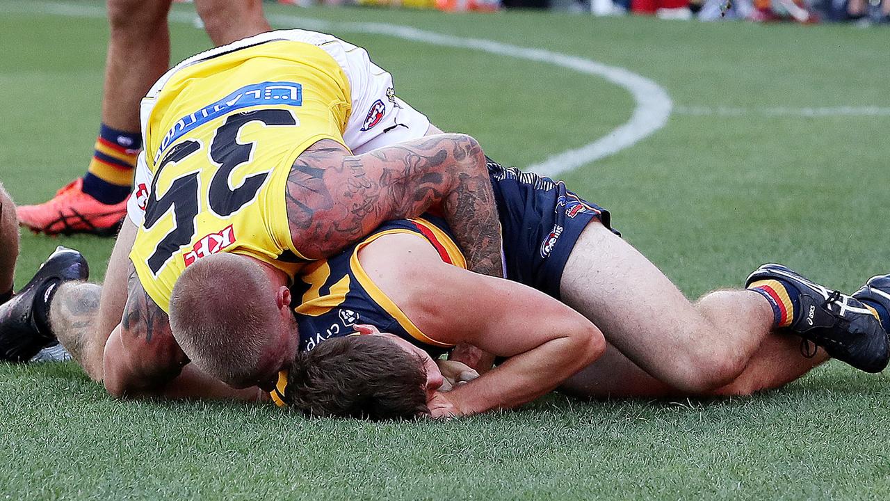 ADELAIDE, AUSTRALIA - MARCH 25: Patrick Parnell of the Crows is tackled by Nathan Broad of the Tigers during the 2023 AFL Round 02 match between the Adelaide Crows and the Richmond Tigers at Adelaide Oval on March 25, 2023 in Adelaide, Australia. (Photo by Sarah Reed/AFL Photos via Getty Images)