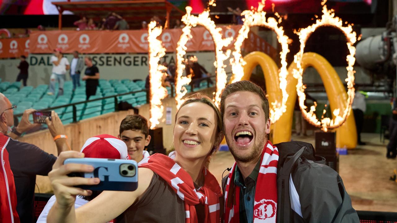 Fans celebrate in front of a pyro display celebrating the magical mark.