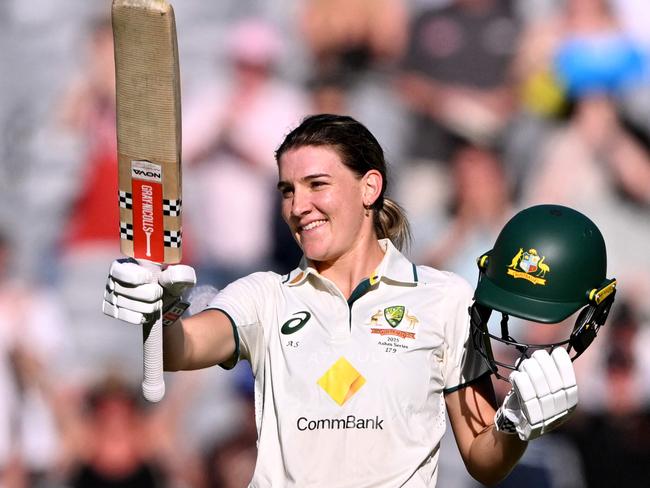 Australia's Annabel Sutherland celebrates scoring her century during the second day of the Women's Ashes cricket Test match between Australia and England at the Melbourne Cricket Ground (MCG) in Melbourne on January 31, 2025. (Photo by William WEST / AFP) / --IMAGE RESTRICTED TO EDITORIAL USE - STRICTLY NO COMMERCIAL USE--