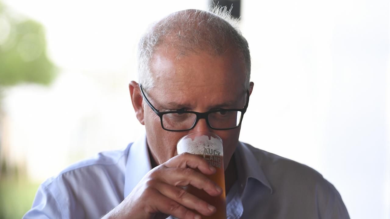 Prime Minister Scott Morrison drinks a beer during a meet and greet event at Auckland House, Gladstone, in January.