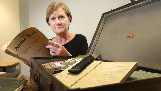 RSPCA Gold Coast branch manager Pam Cordell with a briefcase full of old war memorabilia which was donated. Picture Glenn Hampson