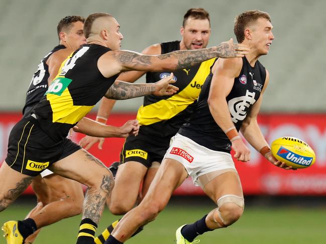 MELBOURNE, AUSTRALIA - MARCH 19: Patrick Cripps of the Blues is tackled by Dustin Martin of the Tigers during the 2020 AFL Round 01 match between the Richmond Tigers and the Carlton Blues at the Melbourne Cricket Ground on March 19, 2020 in Melbourne, Australia. (Photo by Michael Willson/AFL Photos via Getty Images)