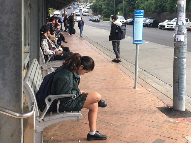 Commuters waiting to get to school and work this morning. Picture: Keely McDonough