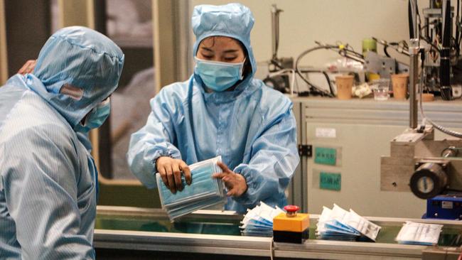 Workers producing face masks at a factory in Yangzhou in China's eastern Jiangsu province. Photo: STR/AFP