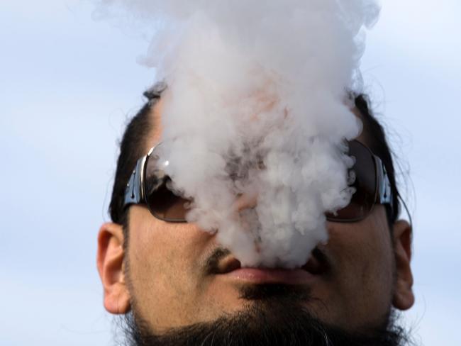 (FILES) In this file photo taken on November 09, 2019, a demonstrator vapes during a rally outside of the White House in Washington, DC, to protest the proposed vaping flavor ban. - The number of US middle and high schoolers using e-cigarettes declined dramatically in 2020 compared to last year, an official report showed on September 9, 2020. The drop came after a large outbreak of e-cigarette linked lung disease last year, and after the US government made legal changes to curb youth vaping. (Photo by Jose Luis Magana / AFP)