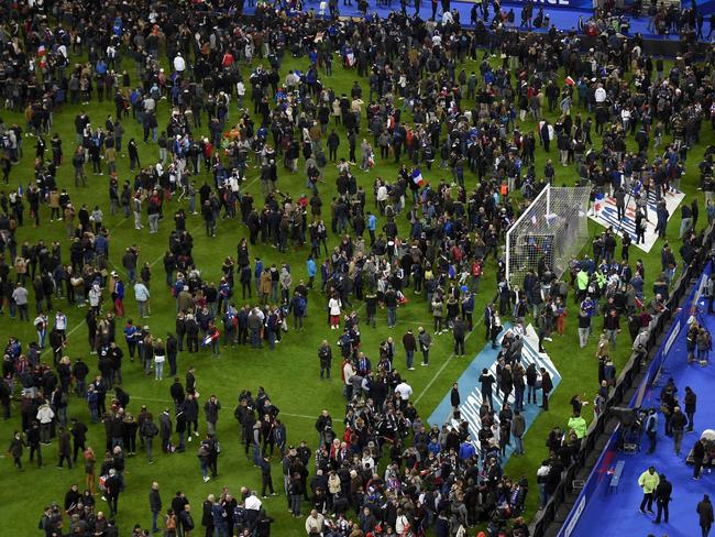 Football fans gather in the field as they wait for security clearance to leave the Stade de France. AFP/Frank Fif.