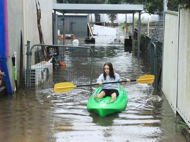 22/3/21: Chloe Panman checks her rabbits at her house at Church street in Windsor which is flooded. John Feder/The Australian