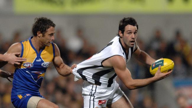 Chad Fletcher chases down Magpie Alan Didak during the extra-time semi final at Subiaco.