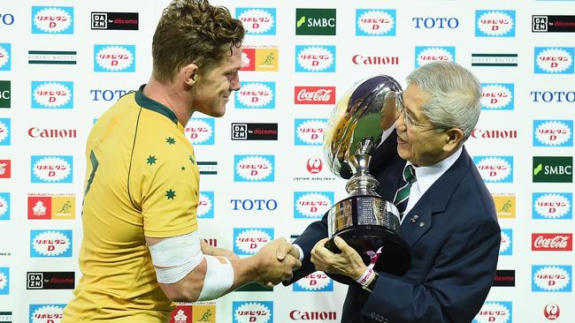 Wallabies captain Michael Hooper is presented with a trophy after beating Japan.