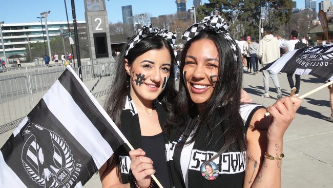 Fans celebrate at the AFL Grand Final Parade in Melbourne. Picture: NCA NewsWire / David Crosling