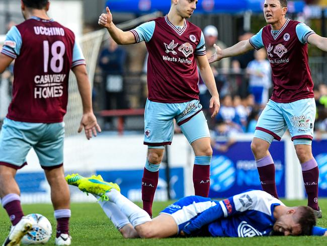 Sydney Olympic star Alejandro Sanchez Lopez in pain after being tackled by APIA. Picture: Brendan Esposito