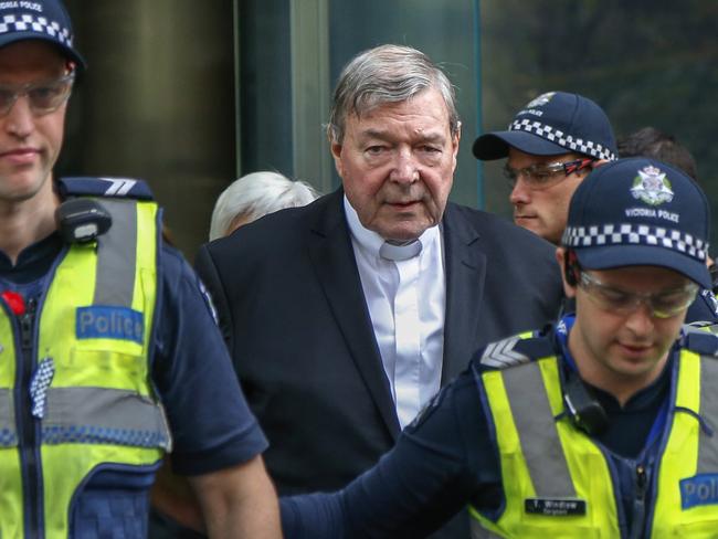 FILE - In this May 2, 2018, file photo, Cardinal George Pell, the most senior Catholic cleric to face sex charges, leaves court in Melbourne, Australia. Pell was sentenced in an Australian court on Wednesday, March 13, 2019 to 6 years in prison for molesting two choirboys in a Melbourne cathedral more than 20 years ago.  (AP Photo/Asanka Brendon Ratnayake, File)