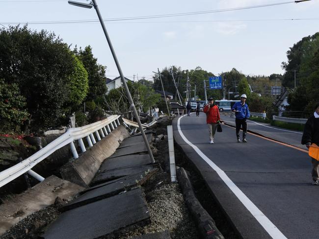 Destroyed ... People walk along a road destroyed by an earthquake in Kumamoto, Japan. Picture: Taro Karibe/Getty Images.