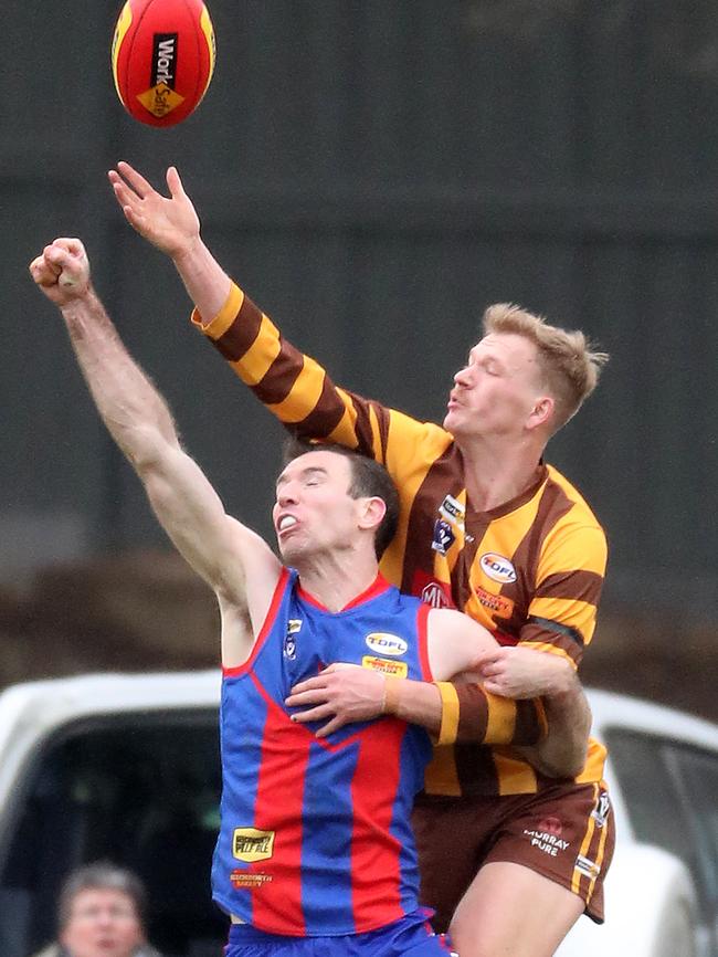 Kiewa-Sandy Creek’s Tristan Mann climbs over the top of Beechworth’s Mitch Anderson.