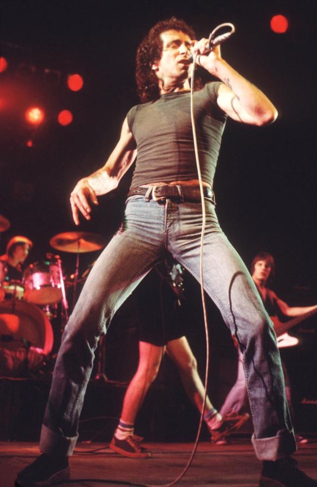 Bon Scott performs on stage with AC/DC, UK, 1976.