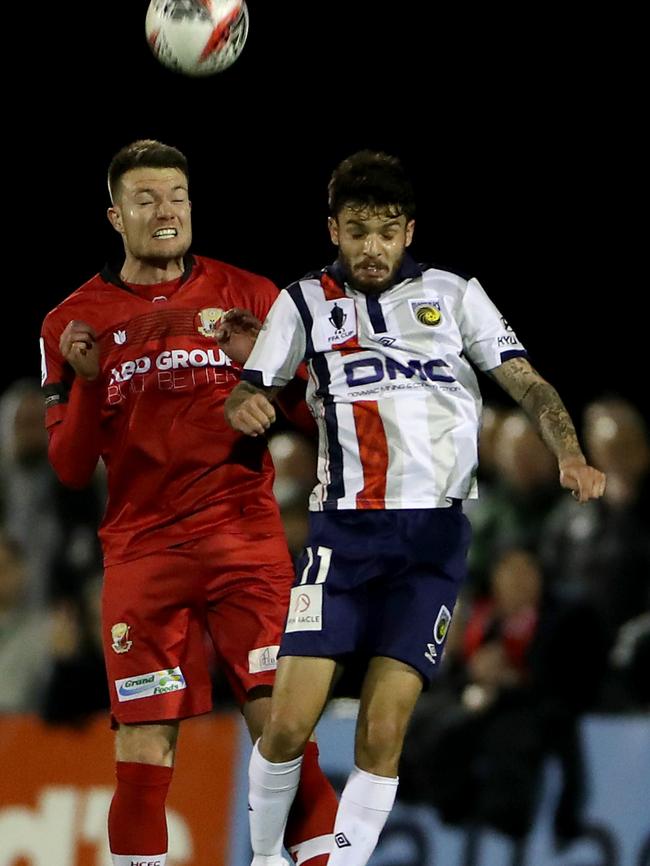 Paul Wilson and Daniel De Silva contest a header.