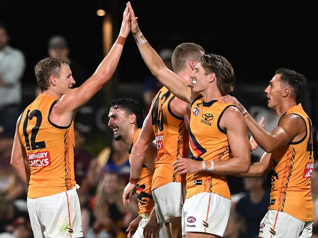 IPSWICH, AUSTRALIA - FEBRUARY 27: Isaac Cumming of the Crows celebrates with team mates after kicking a goal during the 2025 AAMI AFL Community Series match between Brisbane Lions and Adelaide Crows at Brighton Homes Arena on February 27, 2025 in Ipswich, Australia. (Photo by Bradley Kanaris/Getty Images)