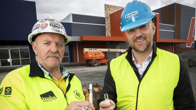 Hutchinson Builders health and safety representative Steve Parkinson, left, and Incolink CEO Erik Locke with the rapid antigen test at Glenorchy. Picture: Chris Kidd