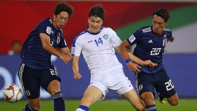 Eldor Shomurodov under pressure from Japan’s defence.