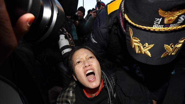 Police officers remove pro-Yoon Suk Yeol supporters outside the official residence of impeached South Korean President Yoon Suk Yeol. Picture: Chung Sung-Jun/Getty Images