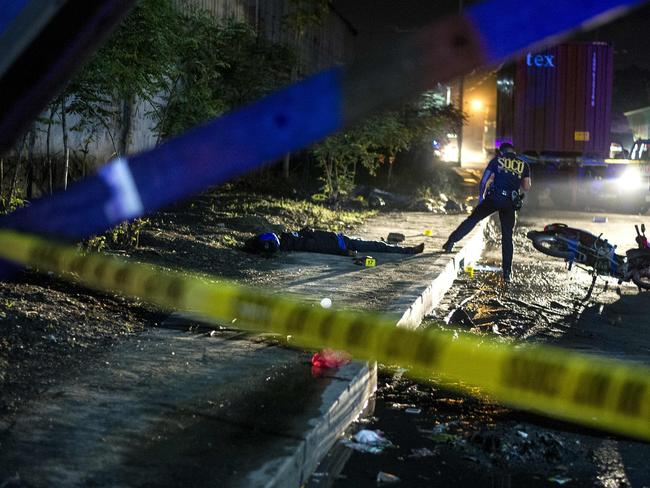 Philippine Scene of the Crime Operatives (SOCO) work at the scene where two suspects were shot dead following an encounter and shootout with police in Manila last month. Picture: Noel Celis