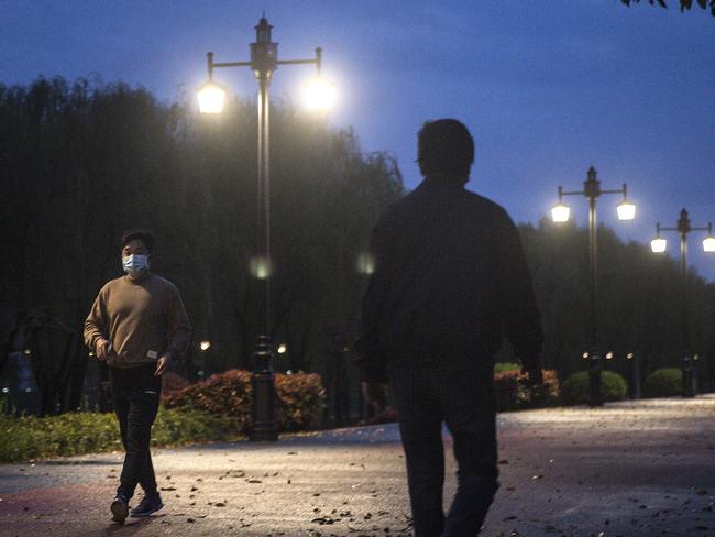 Locals walk in Wuhan. China has closed its borders to foreign nationals. Picture: Getty Images