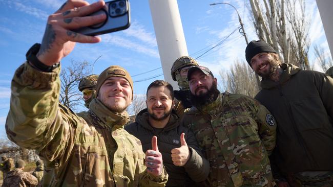 President Volodymyr Zelensky, second left, poses for a photograph with Ukrainian soldiers in Kherson. Picture: AFP/Ukrainian Presidential Press Service