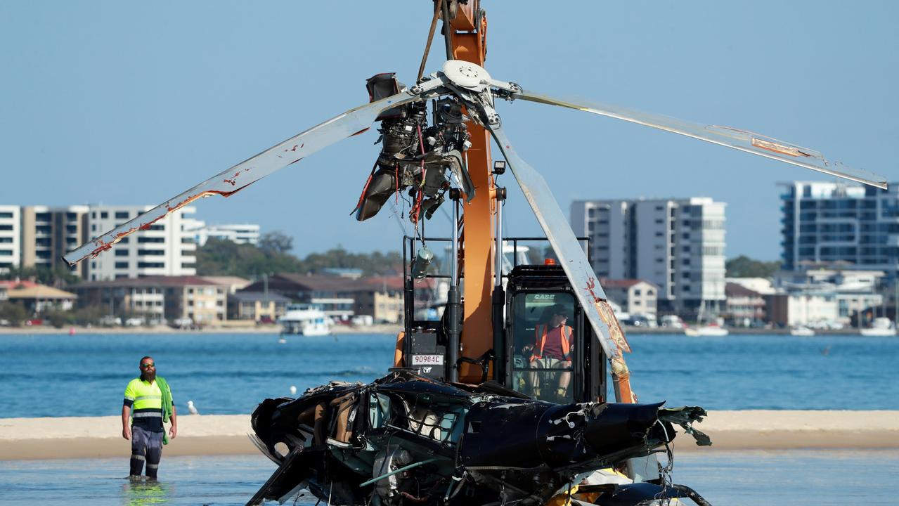 Police and ATSB Officers recover the wreckage from the sandbank near Sea World, on the Gold Coast. Picture Scott Powick