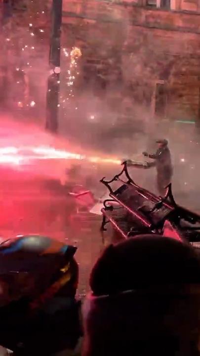 Protesters launch fireworks at riot cops