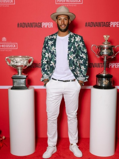 Josh Gibson poses with the Australian Open trophies. Picture: Regina Karon