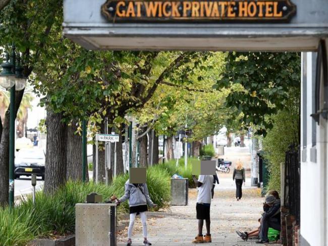 People gather on the footpath outside the Gatwick Hotel in St Kilda, Melbourne which is due to shut down. Picture: Mal Fairclough